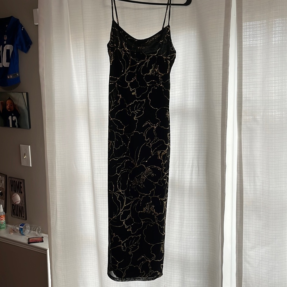 Women’s black and gold midi dress.